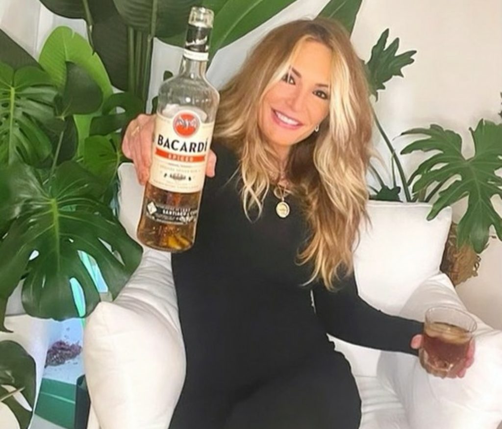 Kate Chastain holding Bacardi Bottle