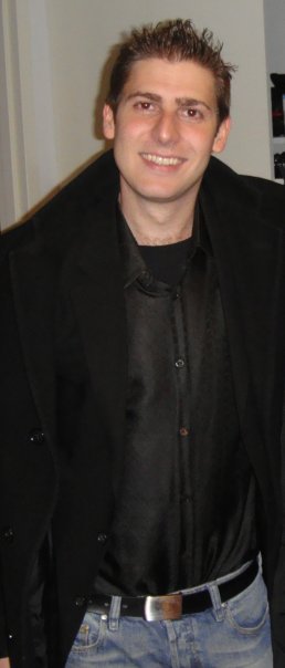 Eduardo Saverin wearing a black jacket and blue jeans.