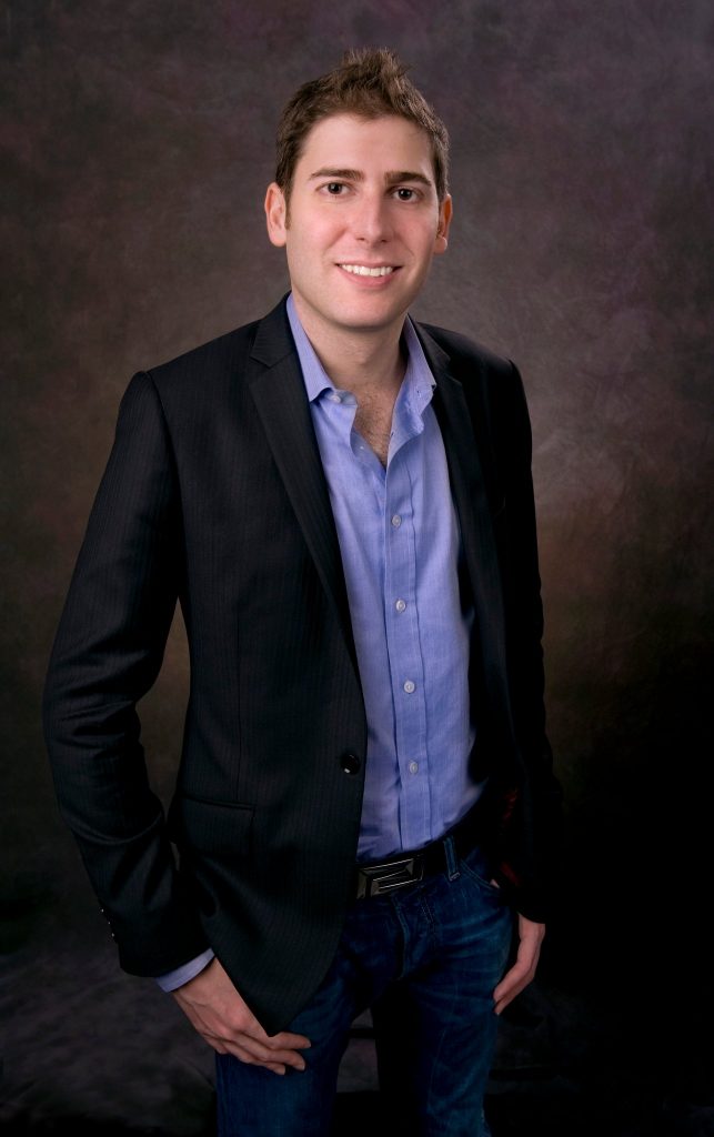 Eduardo Saverin wearing a blue shirt and suit.