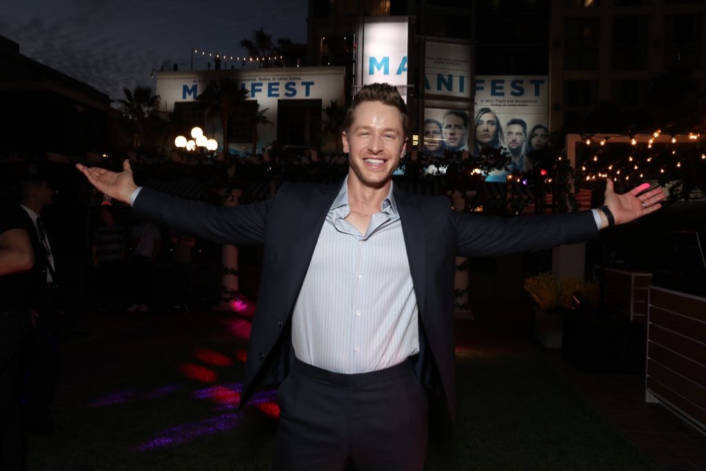 Josh Dallas wearing a black suit posing at the premiere of the series Manifest.