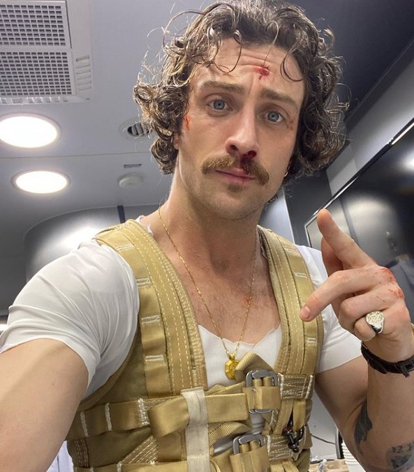 Aaron Taylor-Johnson taking selfie after an action scene.