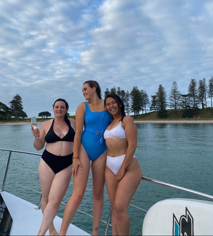 Tyler Mahoney with her friends posing for her swimming costume line
