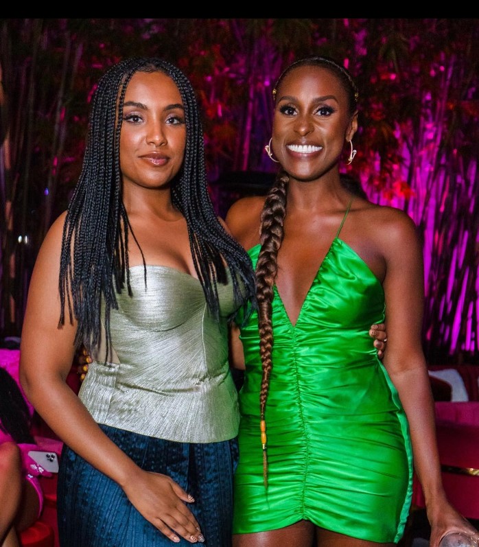 Issa Rae at HBO's Rap Shit event wearing a parrot green bodycon dress.