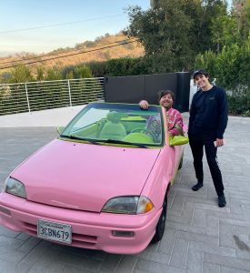 Nick driving a Pink Colored Car