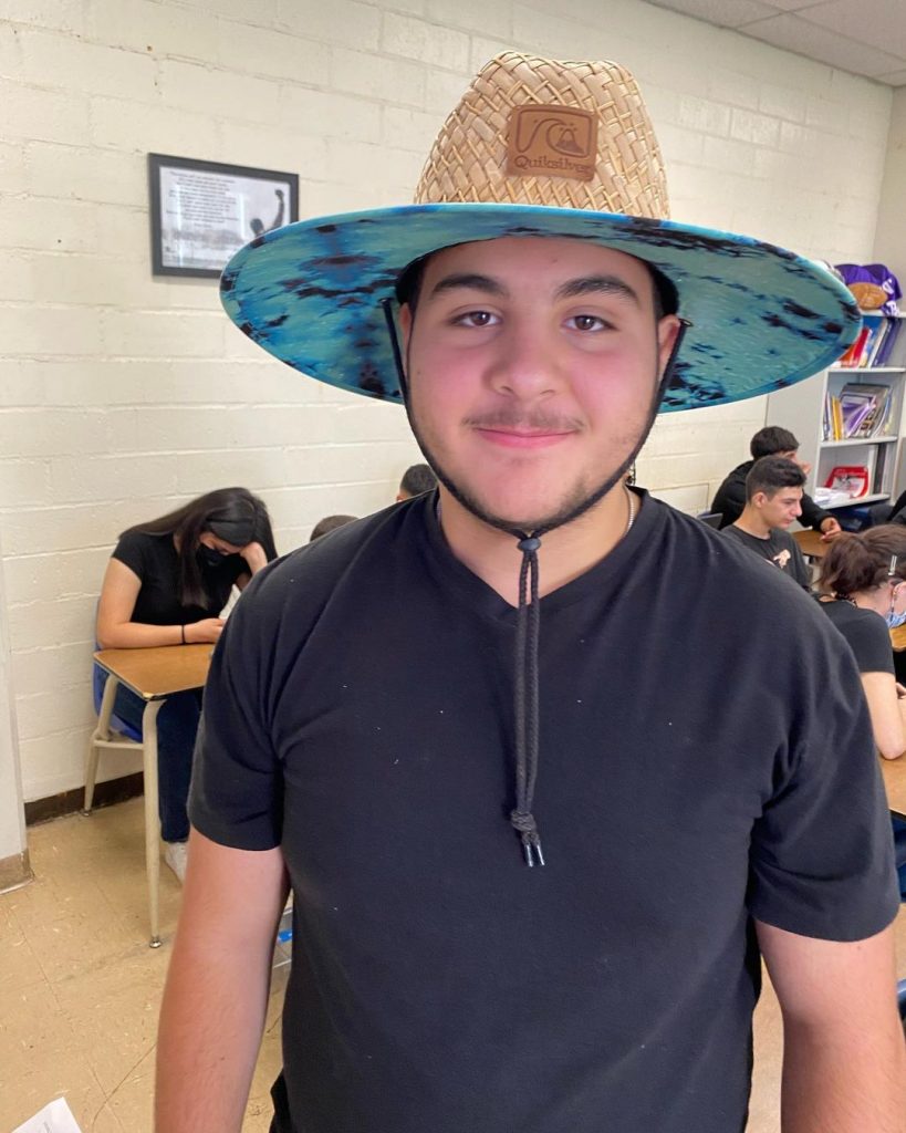 Nick's brother Vardan Antonyan wearing a brown hat and black t shirt.