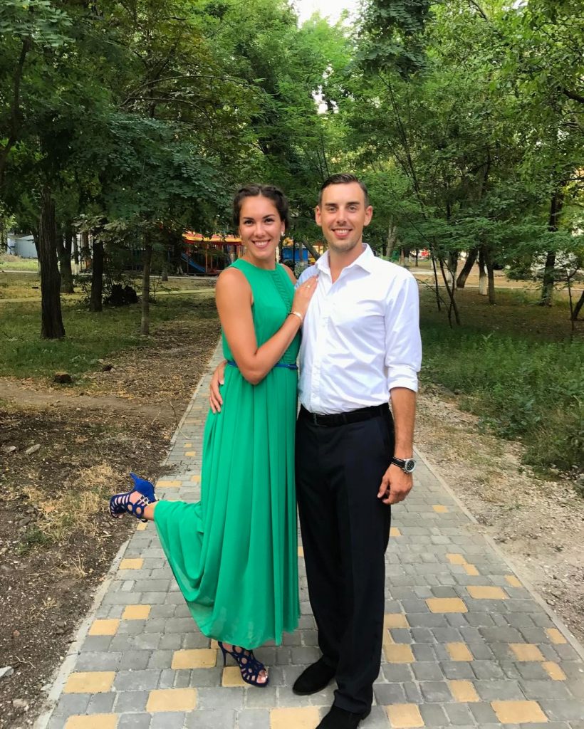 Yuliya and Denis posing in a park together