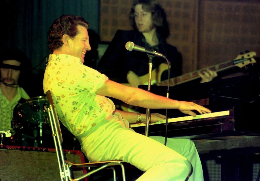 Jerry Lee Lewis performing in a concert.