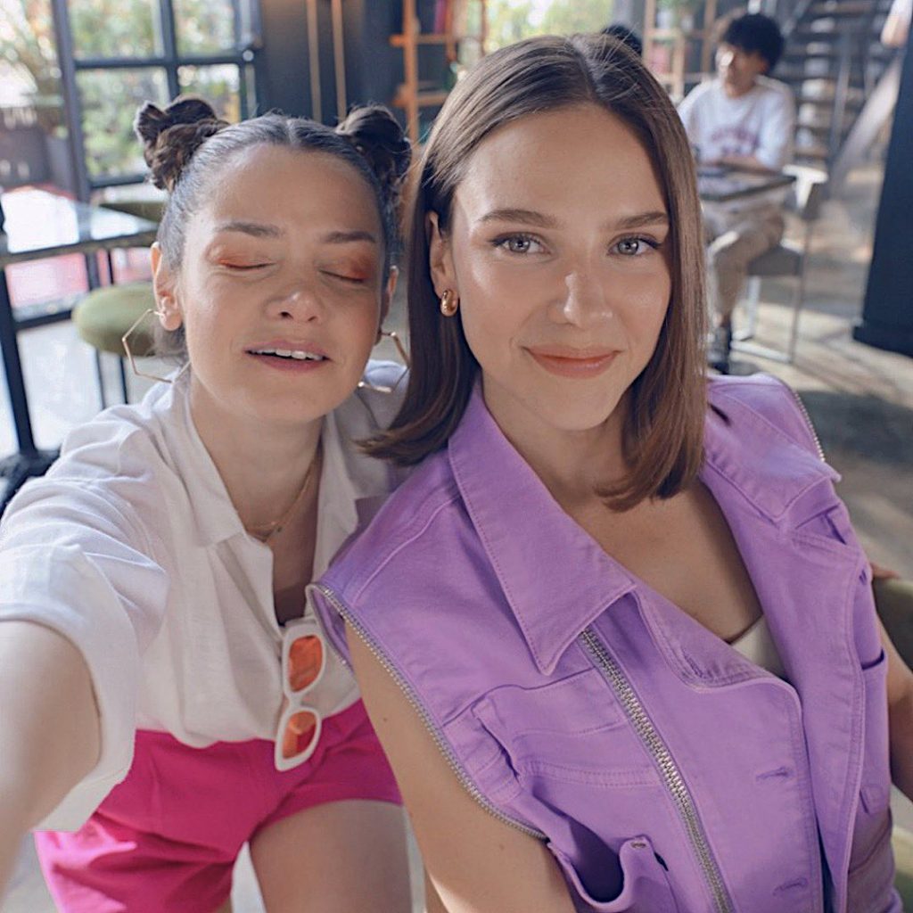 Alina taking selfie with a friend