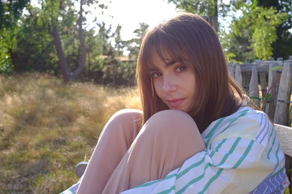 Lily Collins wearing a striped shirt