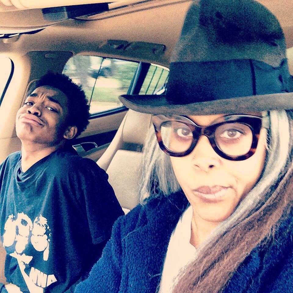 Erykah is driving her car with her son Seven sitting on the other side.