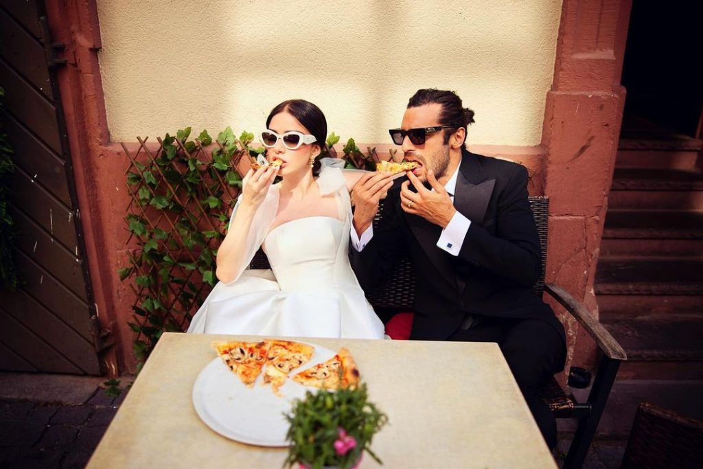 Ogze and Serkan eating pizza after wedding