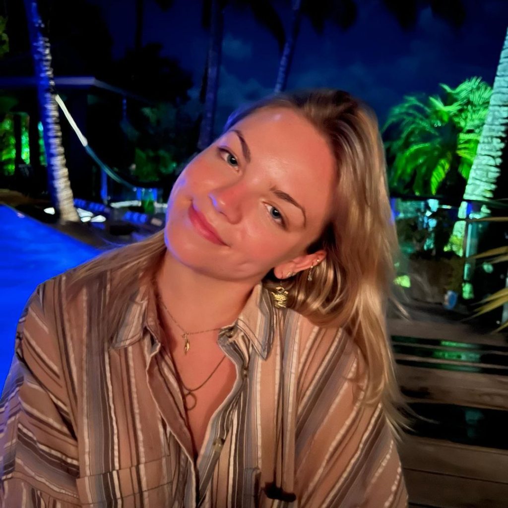 Ella posing for a picture wearing a striped shirt