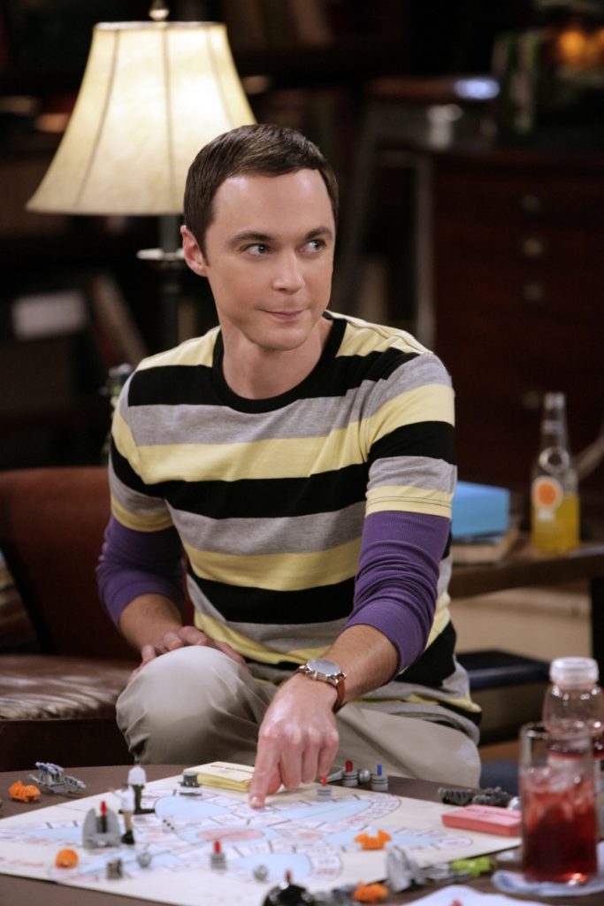 Jim Parsons is wearing a striped t-shirt and playing an indoor game