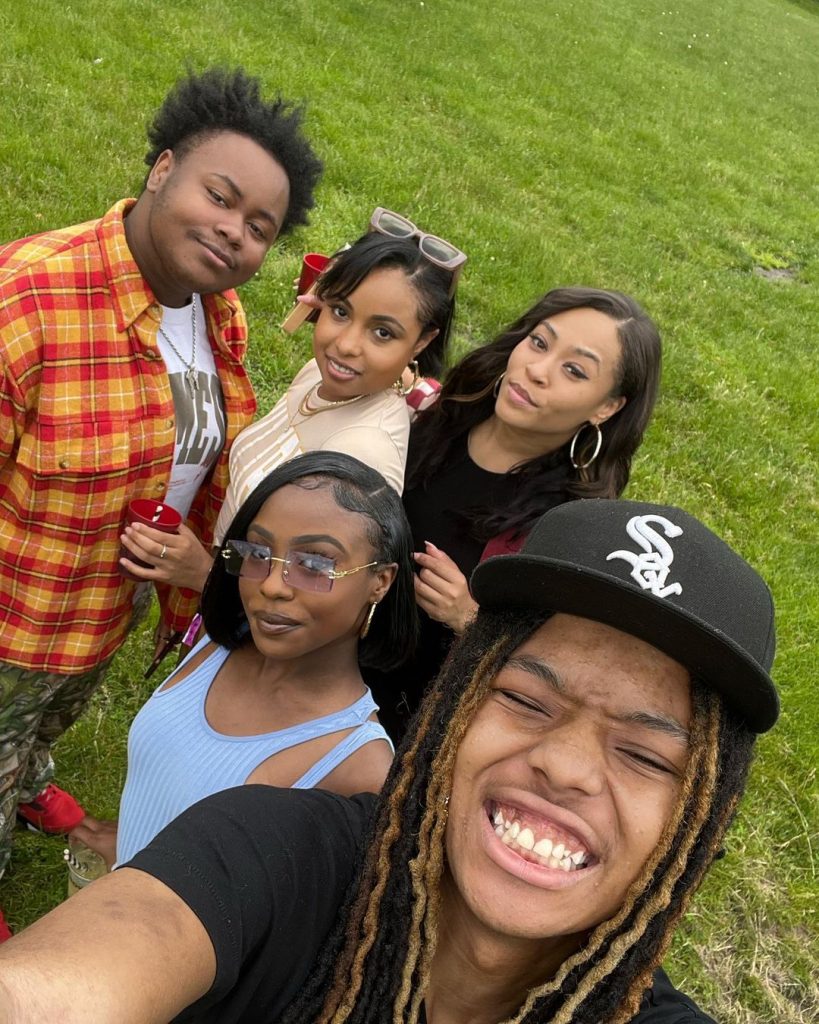 Tai taking selfie with the cast of The Chi