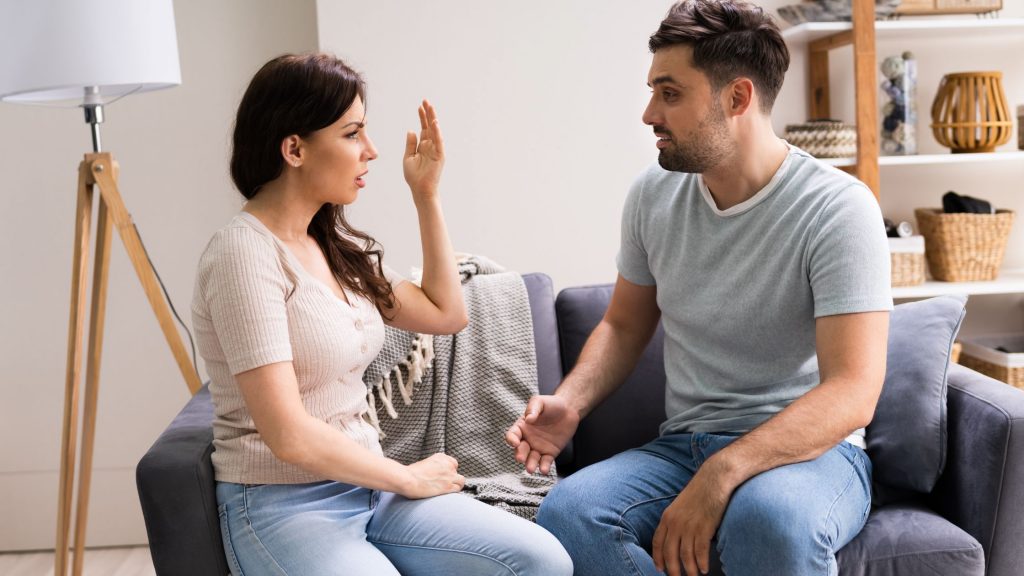 A girl and boy sitting together talking about things.