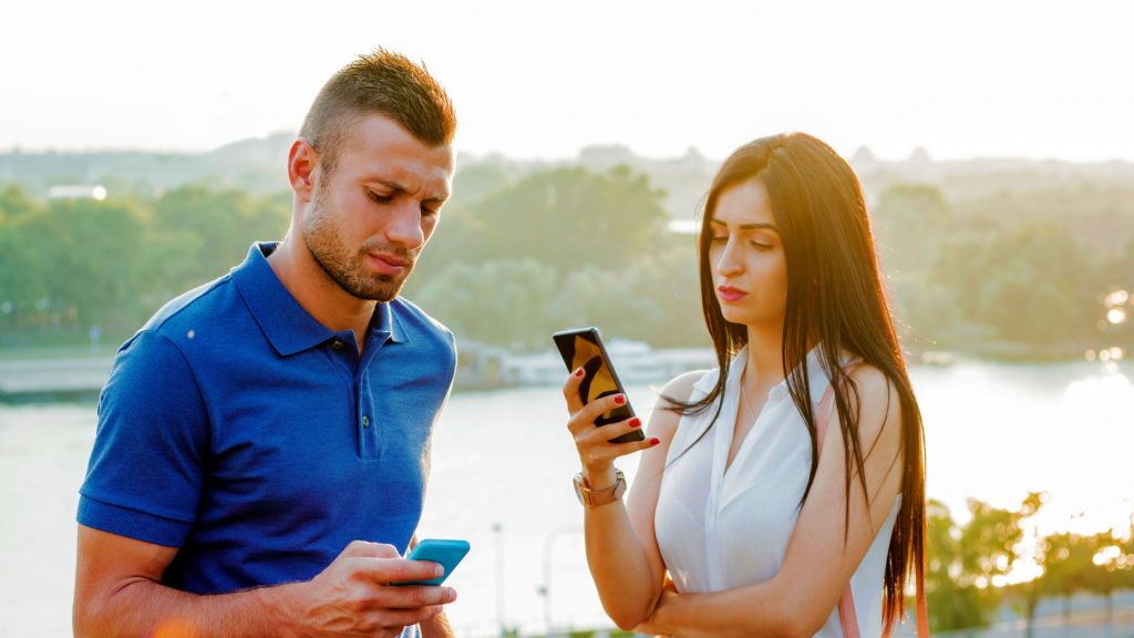  A man and woman busy on phones