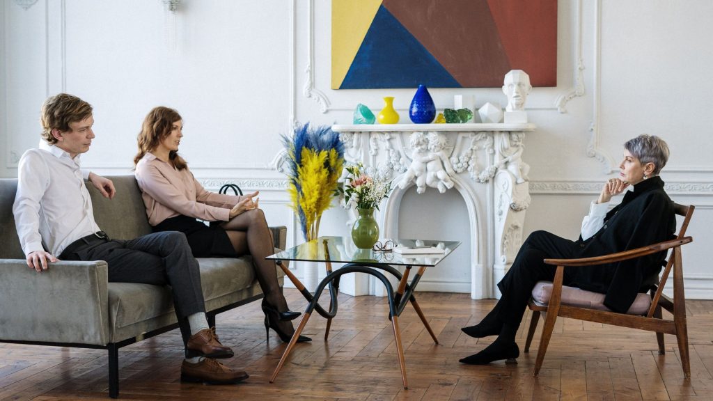 A couple sitting with a lawyer taking advice.