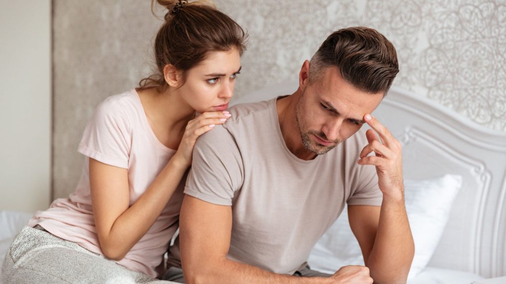 A woman consoling a man.