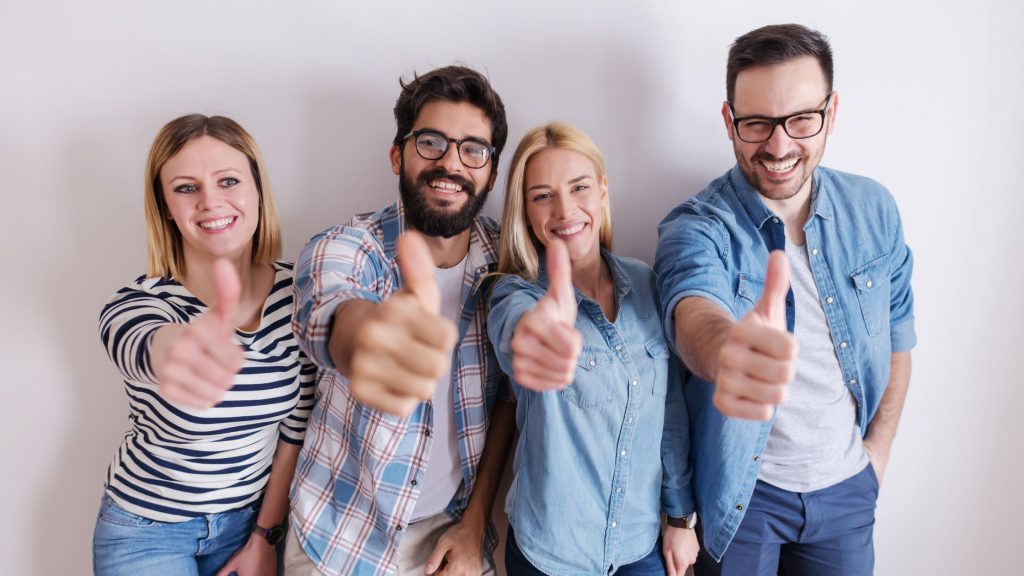 A group of people giving a heads up 