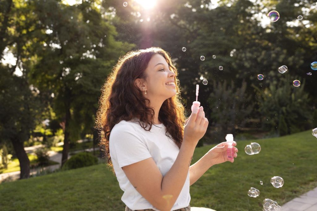 A girl playing with bubbles.