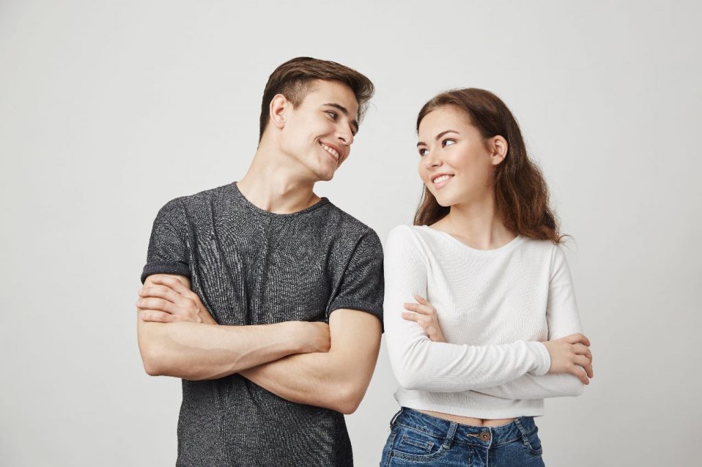 A girl and a boy looking at each other.