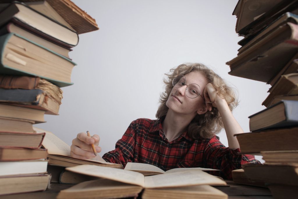 A boy improving his skills by learning through books.