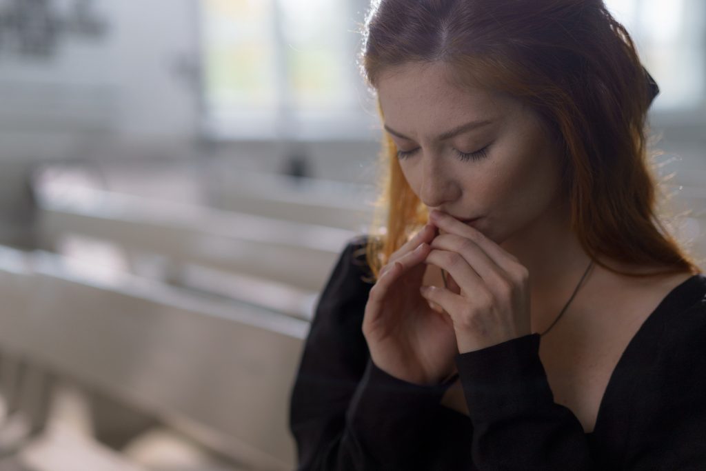 A girl praying  in the church.