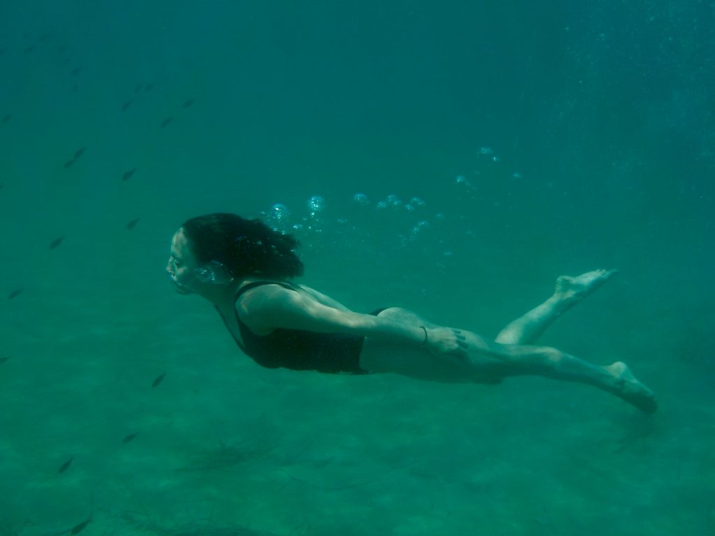 a girl doing underwater diving.