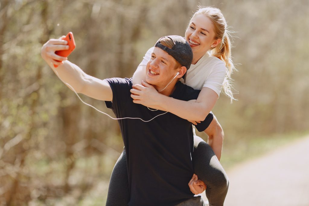 A couple enjoying while taking selfie together.