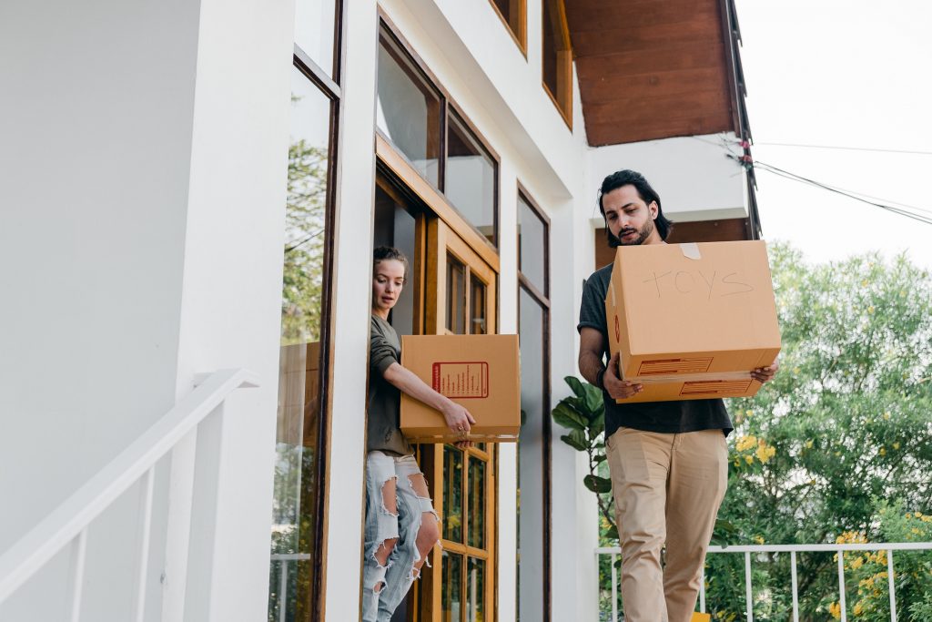 A man and woman shifting boxes together.