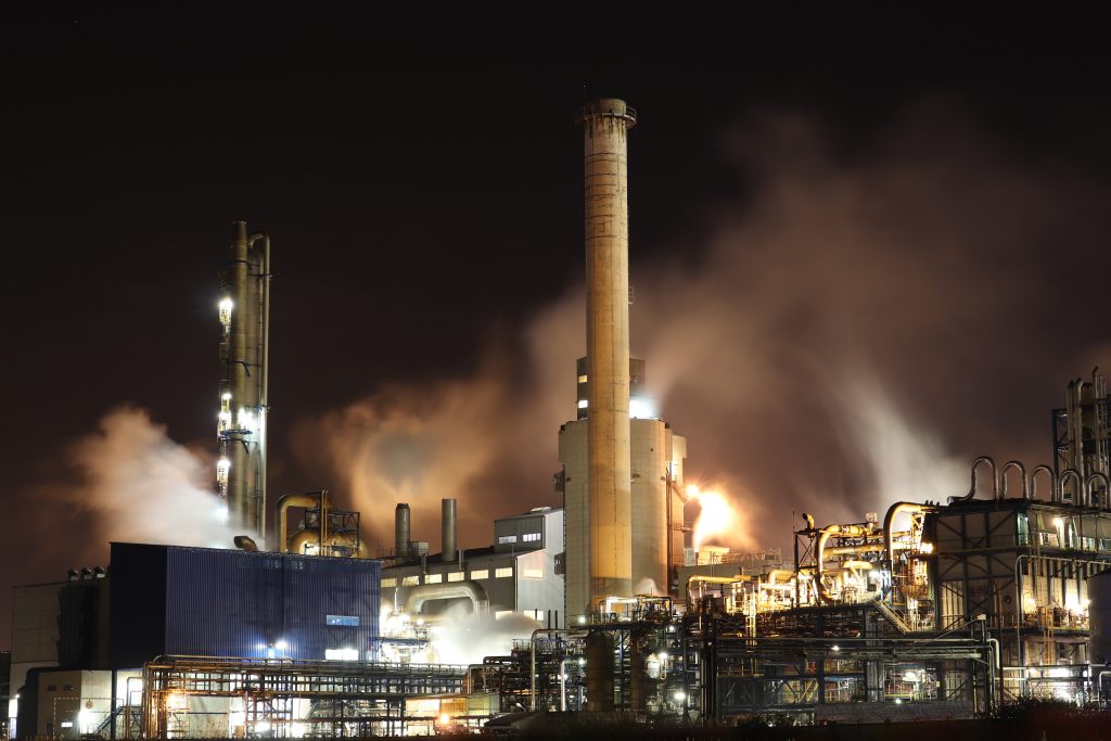 brown-and-white-factory-building-during-night-time