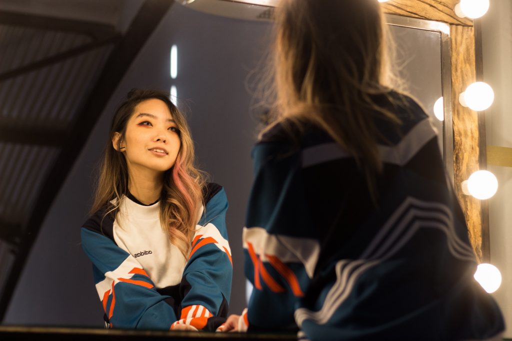 A girl looking into the mirror.