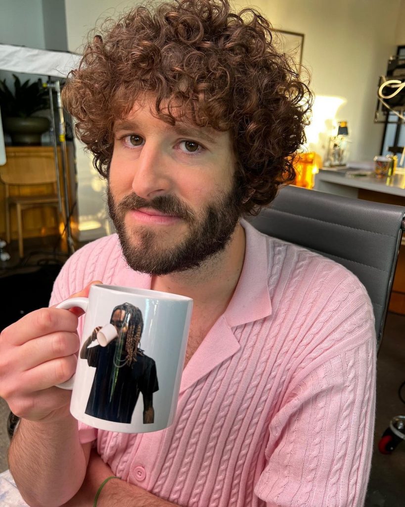 Lil Dicky posing with his mug