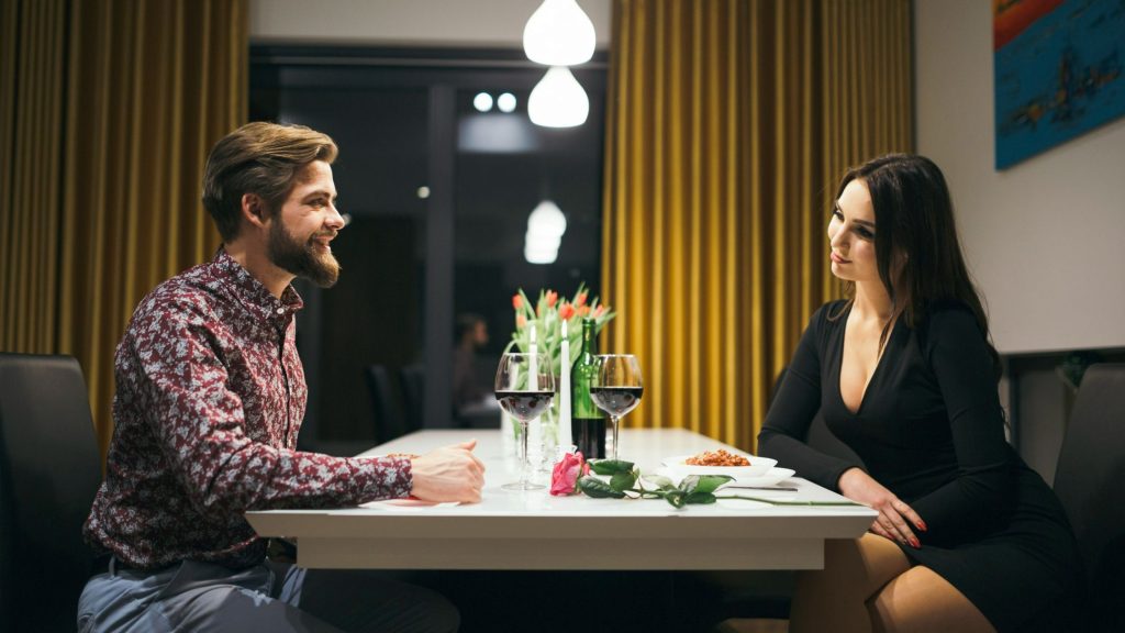 A couple on a romantic candlelit dinner date.