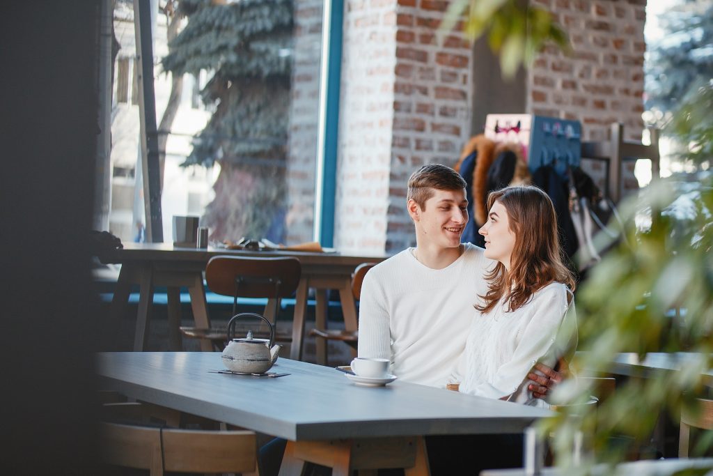 Pretty couple sitting in a cafe. Man and woman drinking a tea