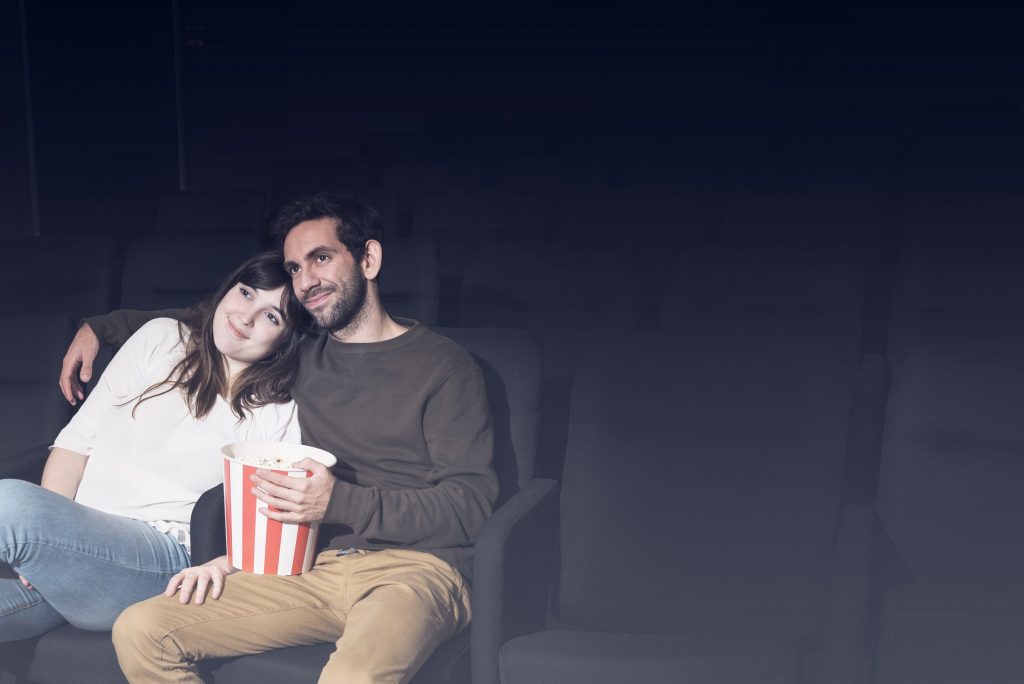 A couple enjoying movie together.