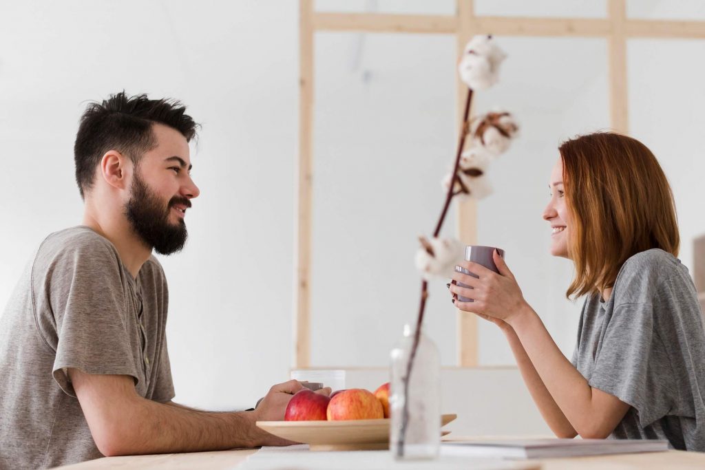 Man and woman talking in the kitchen