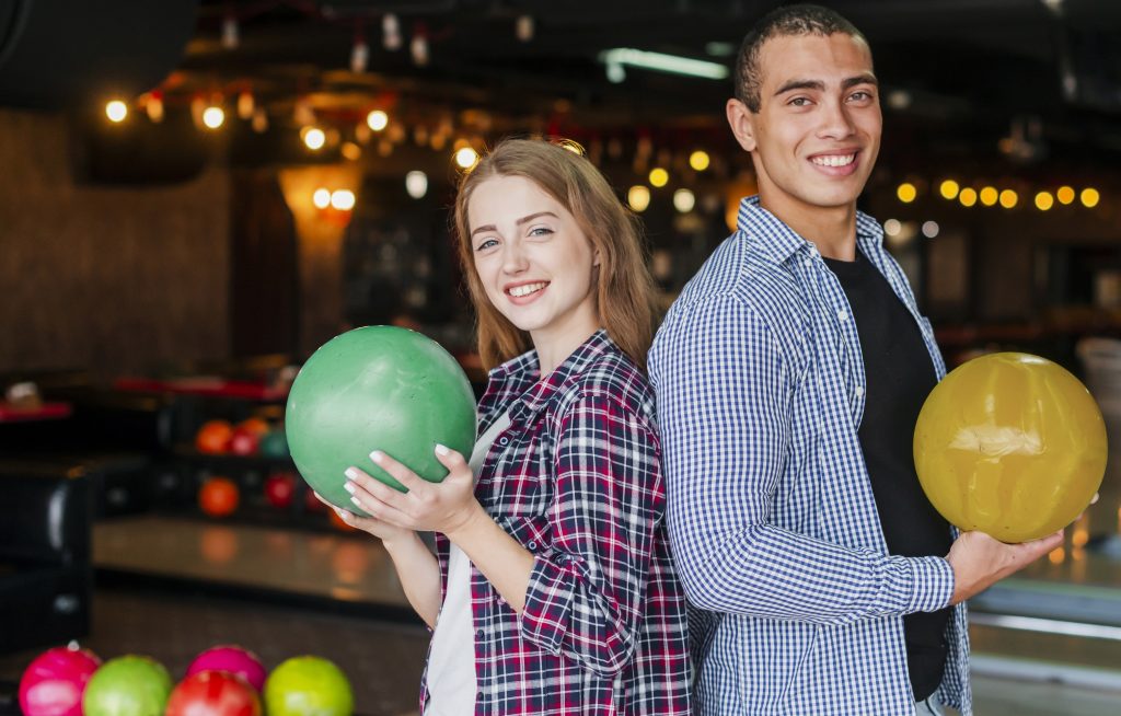 woman-man-holding-colorful-bowling-balls